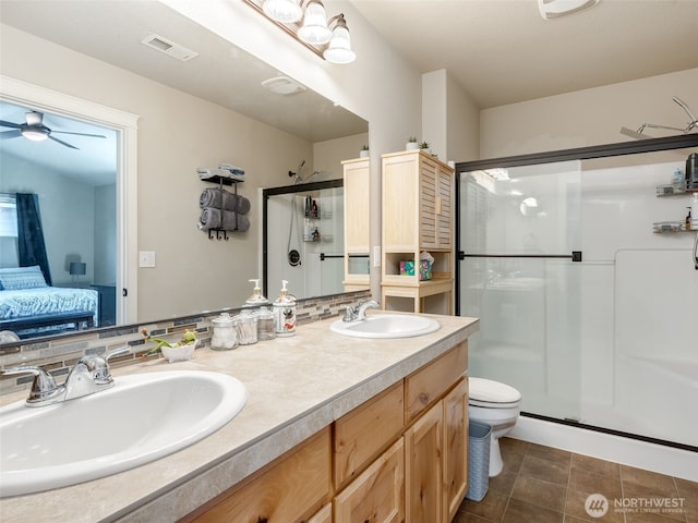 2962 26th Ave, Forest Grove, OR 97116 - ensuite bathroom with a stall shower, double vanity, ceiling fan, toilet, and tile patterned flooring