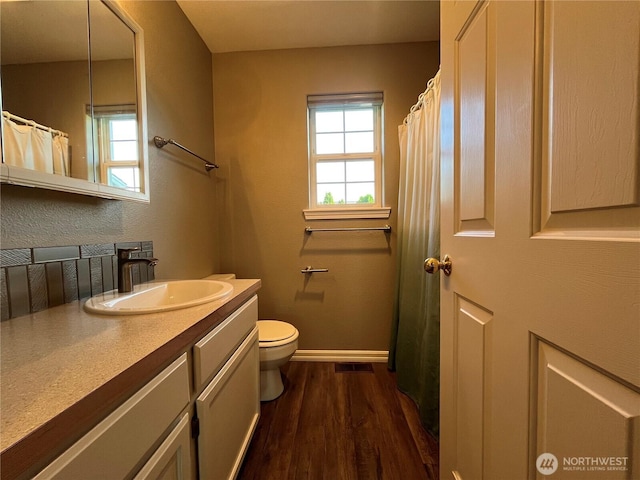 1516 4th St, Wenatchee, WA 98801 - bathroom featuring wood finished floors, vanity, toilet, and baseboards