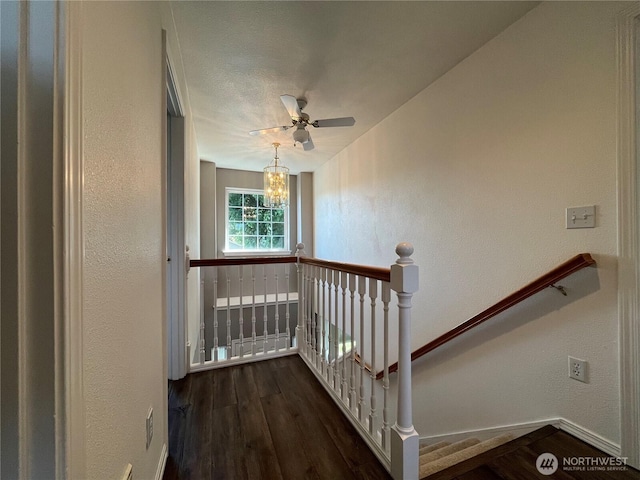 1516 4th St, Wenatchee, WA 98801 - staircase featuring a textured wall, wood finished floors, baseboards, a chandelier, and a ceiling fan