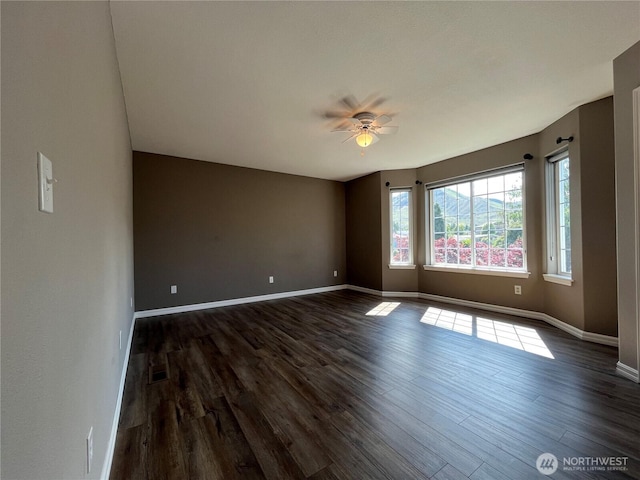 1516 4th St, Wenatchee, WA 98801 - empty room with dark wood-type flooring, ceiling fan, and baseboards
