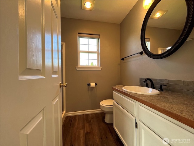 1516 4th St, Wenatchee, WA 98801 - bathroom with wood finished floors, toilet, vanity, and baseboards