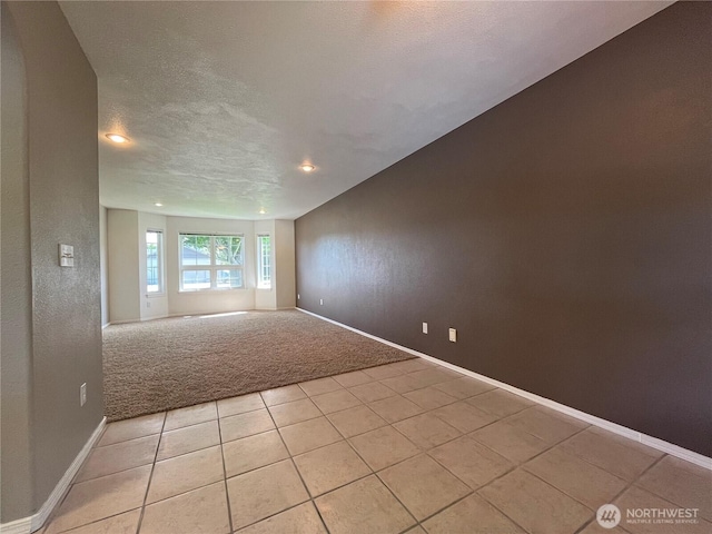 1516 4th St, Wenatchee, WA 98801 - unfurnished room with light tile patterned floors, light colored carpet, baseboards, recessed lighting, and a textured ceiling