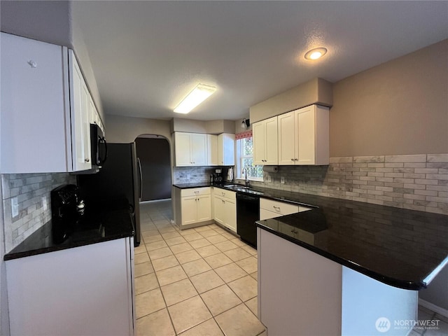 1516 4th St, Wenatchee, WA 98801 - kitchen with black appliances, a peninsula, decorative backsplash, a sink, and light tile patterned floors