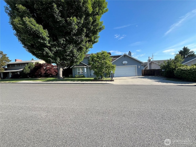1516 4th St, Wenatchee, WA 98801 - obstructed view of property featuring concrete driveway and a garage