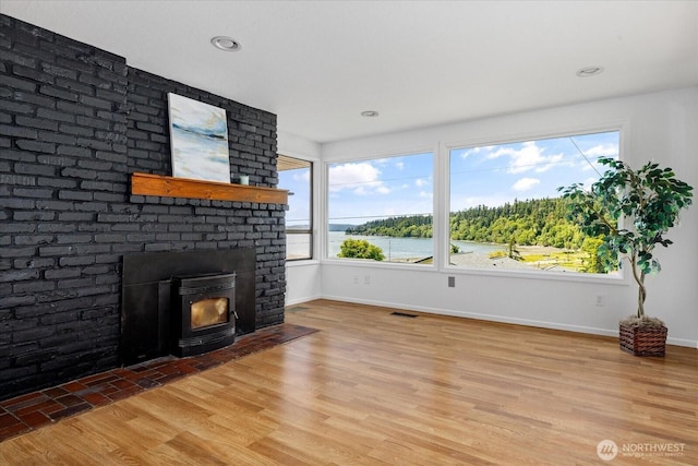 13371 Eagle St, Anacortes, WA 98221 - unfurnished living room featuring baseboards, light wood-style floors, a fireplace, and recessed lighting