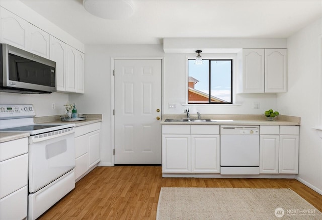 13371 Eagle St, Anacortes, WA 98221 - kitchen with white appliances, white cabinetry, a sink, and light wood-style floors