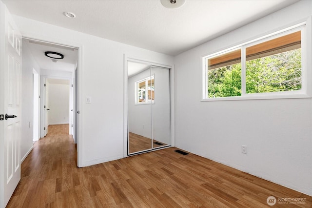 13371 Eagle St, Anacortes, WA 98221 - unfurnished bedroom featuring wood finished floors, multiple windows, and a closet