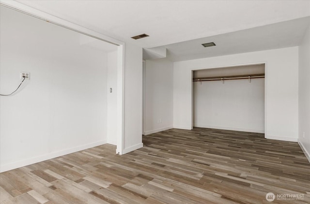 13371 Eagle St, Anacortes, WA 98221 - unfurnished bedroom featuring a closet, wood finished floors, and baseboards