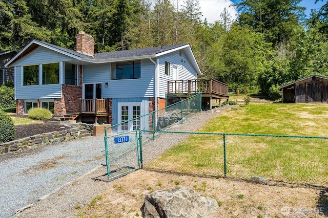 13371 Eagle St, Anacortes, WA 98221 - rear view of house with a chimney, a gate, a wooden deck, and brick siding