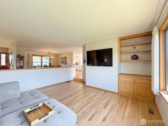 22 E Bedinger Rd, Sequim, WA 98382 - living area featuring a chandelier, light wood-style flooring, and baseboards
