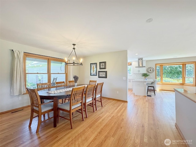 22 E Bedinger Rd, Sequim, WA 98382 - dining room with light wood-type flooring, a chandelier, and baseboards