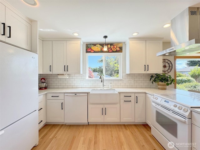 22 E Bedinger Rd, Sequim, WA 98382 - kitchen with white appliances, wall chimney range hood, a sink, plenty of natural light, and recessed lighting