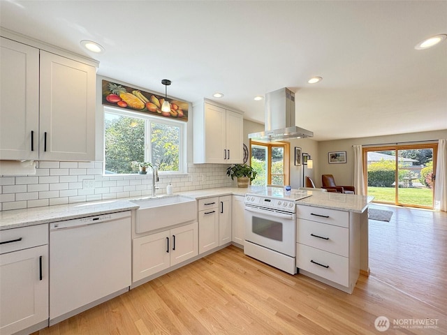 22 E Bedinger Rd, Sequim, WA 98382 - kitchen featuring white appliances, island exhaust hood, a peninsula, light wood-type flooring, and recessed lighting