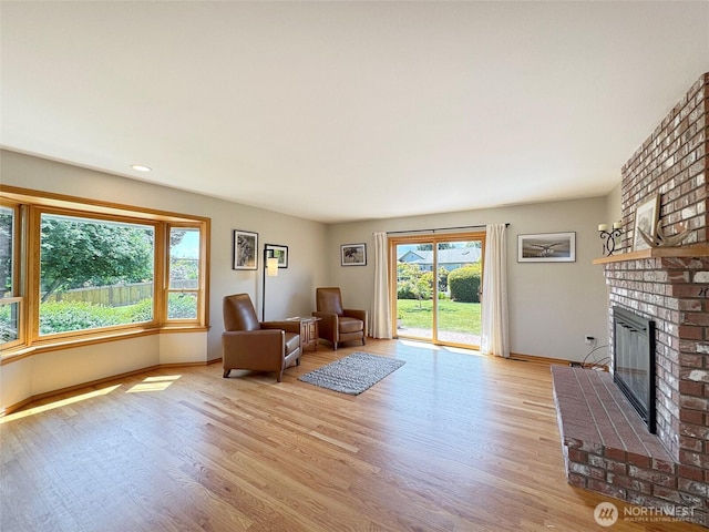 22 E Bedinger Rd, Sequim, WA 98382 - living room with a brick fireplace, wood finished floors, baseboards, and recessed lighting