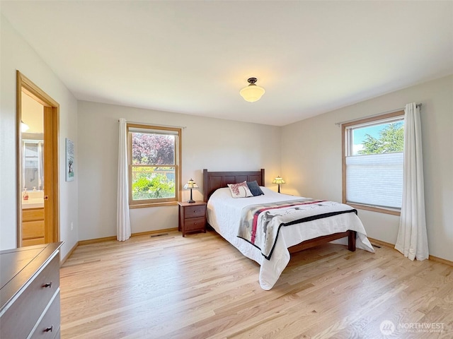 22 E Bedinger Rd, Sequim, WA 98382 - bedroom with multiple windows, light wood finished floors, and baseboards