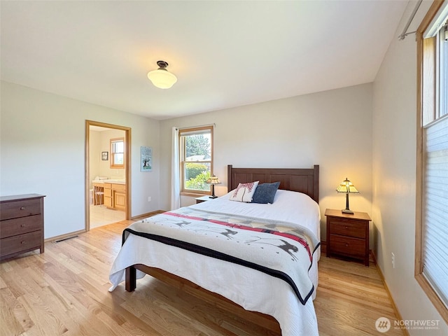22 E Bedinger Rd, Sequim, WA 98382 - bedroom featuring light wood-style flooring, baseboards, and connected bathroom