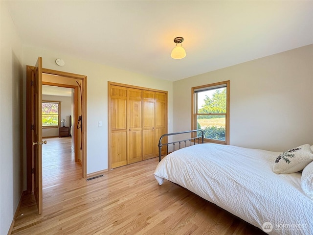 22 E Bedinger Rd, Sequim, WA 98382 - bedroom featuring light wood-style floors, a closet, and baseboards