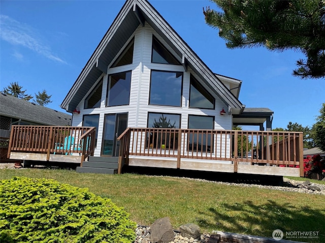 327 Cockle St SW, Ocean Shores, WA 98569 - rear view of house with a wooden deck and a lawn