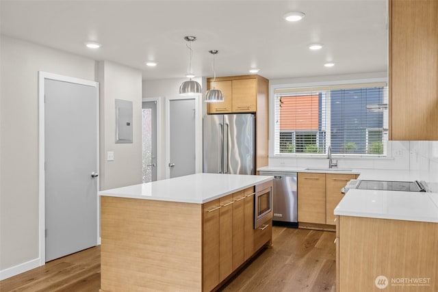 5915 Fauntleroy Way SW Unit C, Seattle, WA 98136 - kitchen with appliances with stainless steel finishes, a sink, electric panel, wood finished floors, and a kitchen island