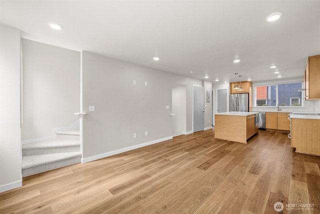 5915 Fauntleroy Way SW Unit C, Seattle, WA 98136 - kitchen featuring freestanding refrigerator, a center island, light countertops, recessed lighting, and light wood-type flooring