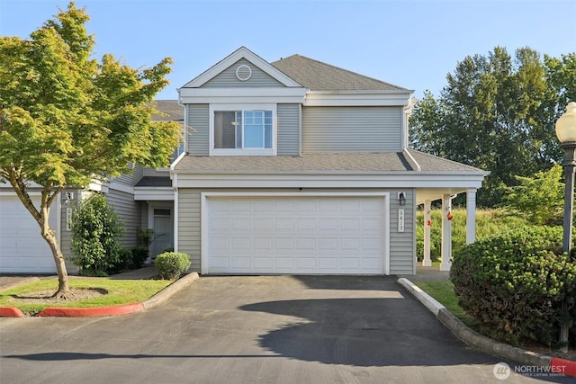 5417 S 237th Pl Unit 14-4, Kent, WA 98032 - traditional home featuring an attached garage, asphalt driveway, and a shingled roof