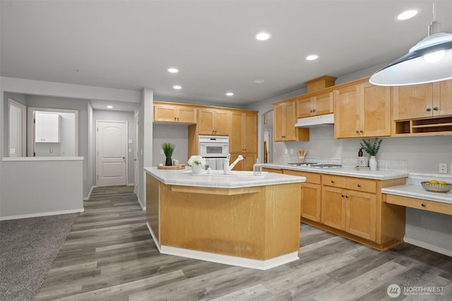 2804 177th, Vancouver, WA 98682 - kitchen featuring white appliances, under cabinet range hood, a sink, light countertops, and a kitchen island with sink