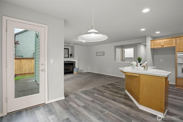 2804 177th, Vancouver, WA 98682 - kitchen with a fireplace, recessed lighting, light countertops, dark wood finished floors, and hanging light fixtures