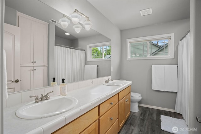 2804 177th, Vancouver, WA 98682 - full bathroom with toilet, double vanity, wood finished floors, baseboards, and a chandelier