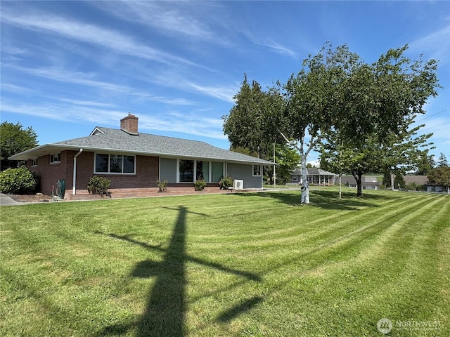 851 Heichel Rd, Camano Island, WA 98282 - rear view of house with a yard, a chimney, and brick siding