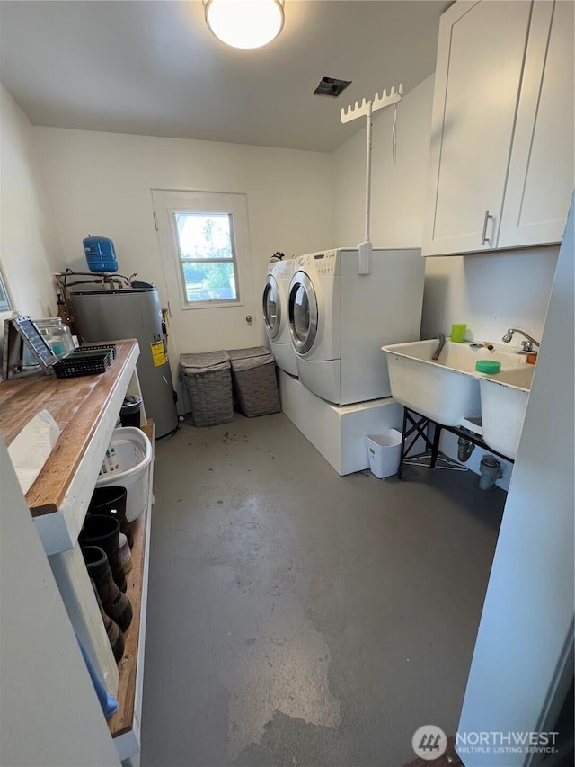851 Heichel Rd, Camano Island, WA 98282 - laundry area featuring washing machine and clothes dryer, water heater, and cabinet space