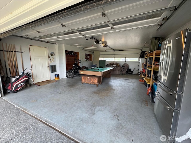 851 Heichel Rd, Camano Island, WA 98282 - garage featuring freestanding refrigerator and a garage door opener