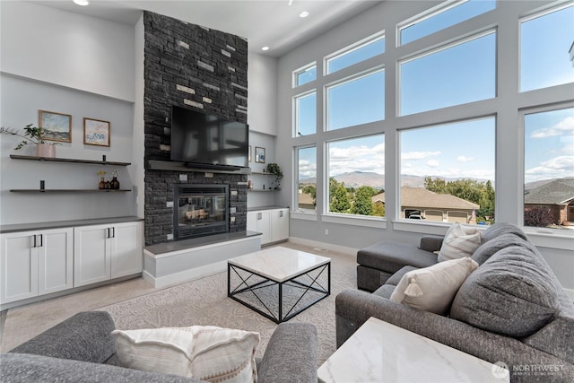 1425 Appleridge St, Wenatchee, WA 98801 - living room featuring plenty of natural light, a large fireplace, baseboards, a towering ceiling, and recessed lighting