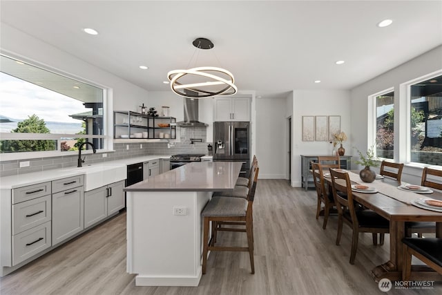 1425 Appleridge St, Wenatchee, WA 98801 - kitchen with wall chimney exhaust hood, appliances with stainless steel finishes, decorative backsplash, open shelves, and a chandelier