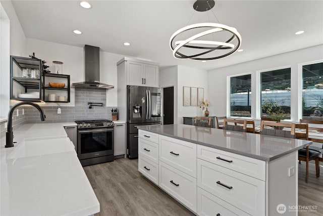 1425 Appleridge St, Wenatchee, WA 98801 - kitchen with appliances with stainless steel finishes, wall chimney exhaust hood, a sink, recessed lighting, and decorative backsplash