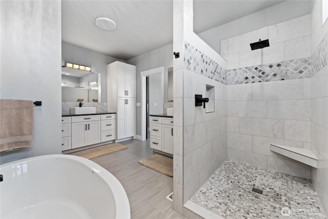 1425 Appleridge St, Wenatchee, WA 98801 - bathroom featuring a tile shower, vanity, a soaking tub, and wood finished floors