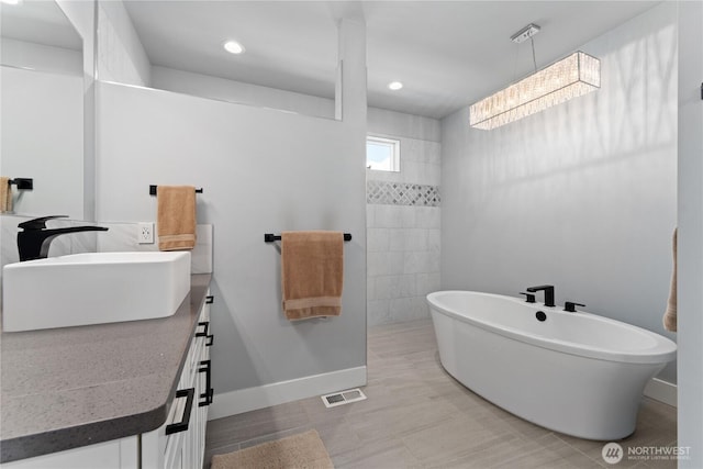 1425 Appleridge St, Wenatchee, WA 98801 - full bathroom with vanity, a freestanding tub, recessed lighting, and baseboards