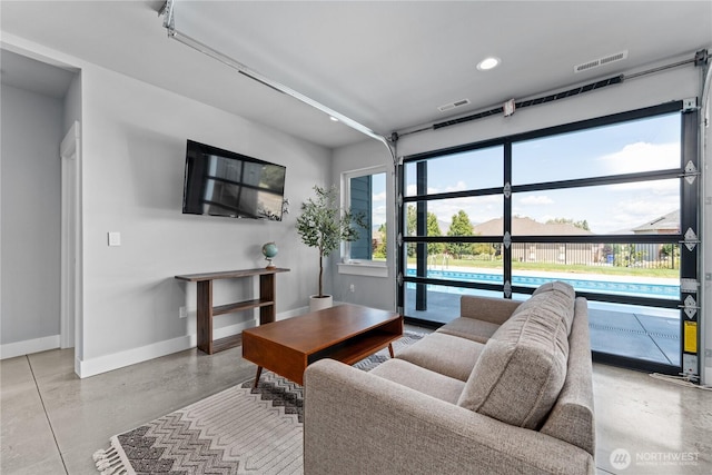 1425 Appleridge St, Wenatchee, WA 98801 - living area featuring concrete flooring, baseboards, and recessed lighting