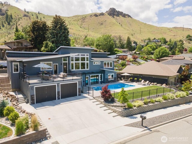 1425 Appleridge St, Wenatchee, WA 98801 - rear view of house featuring a mountain view, a garage, and concrete driveway