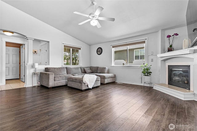 7382 Halibut Dr, Blaine, WA 98230 - living area featuring lofted ceiling, wood finished floors, a ceiling fan, a glass covered fireplace, and baseboards