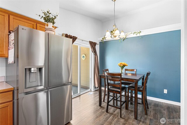 7382 Halibut Dr, Blaine, WA 98230 - dining area with a chandelier, dark wood-style flooring, and baseboards
