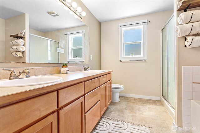 7382 Halibut Dr, Blaine, WA 98230 - bathroom with a shower stall, double vanity, baseboards, toilet, and stone finish flooring