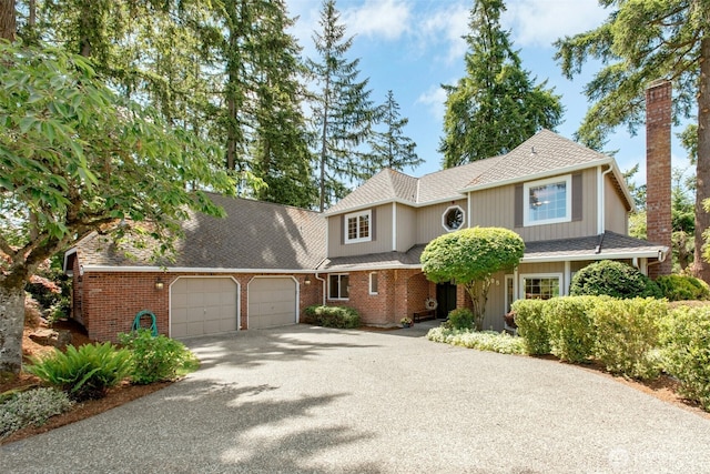 1805 179th Pl NE, Bellevue, WA 98008 - view of front of home with an attached garage, asphalt driveway, brick siding, and a shingled roof
