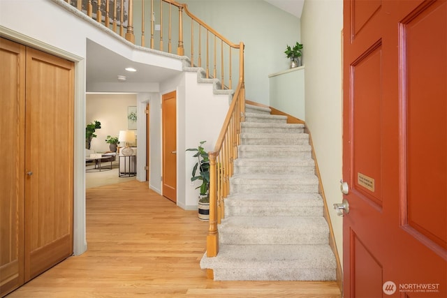 1211 6th Pl S, Edmonds, WA 98020 - staircase featuring wood finished floors, baseboards, a towering ceiling, and recessed lighting