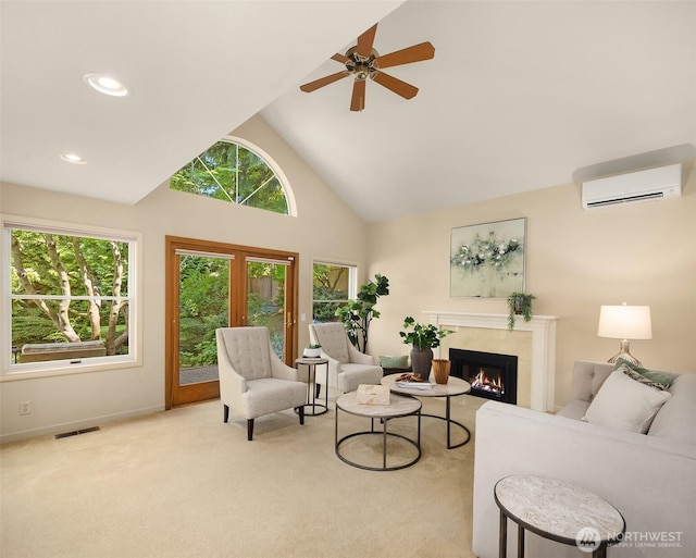 1211 6th Pl S, Edmonds, WA 98020 - living area featuring a wall unit AC, a warm lit fireplace, high vaulted ceiling, carpet floors, and a ceiling fan