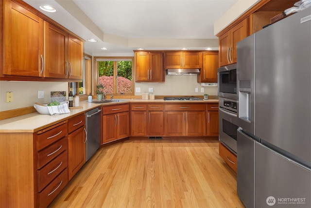 1211 6th Pl S, Edmonds, WA 98020 - kitchen featuring stainless steel appliances, brown cabinets, light wood finished floors, recessed lighting, and light countertops