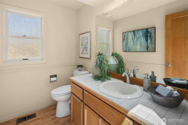 1211 6th Pl S, Edmonds, WA 98020 - bathroom with vanity, toilet, wood finished floors, and baseboards