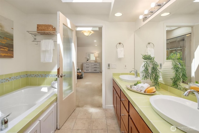 1211 6th Pl S, Edmonds, WA 98020 - full bath with double vanity, tile patterned flooring, and a garden tub