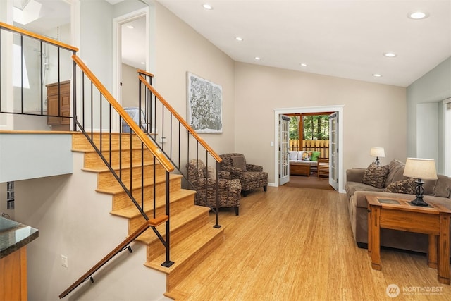 23018 NE 25th Way, Sammamish, WA 98074 - living room with light wood-style floors, recessed lighting, stairs, baseboards, and high vaulted ceiling