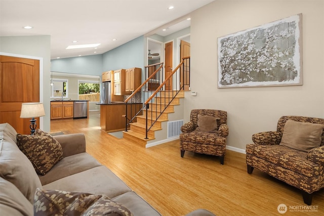 23018 NE 25th Way, Sammamish, WA 98074 - living room with light wood-type flooring, stairway, recessed lighting, baseboards, and vaulted ceiling