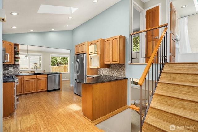 23018 NE 25th Way, Sammamish, WA 98074 - kitchen featuring appliances with stainless steel finishes, a peninsula, light wood-style floors, a skylight, and recessed lighting